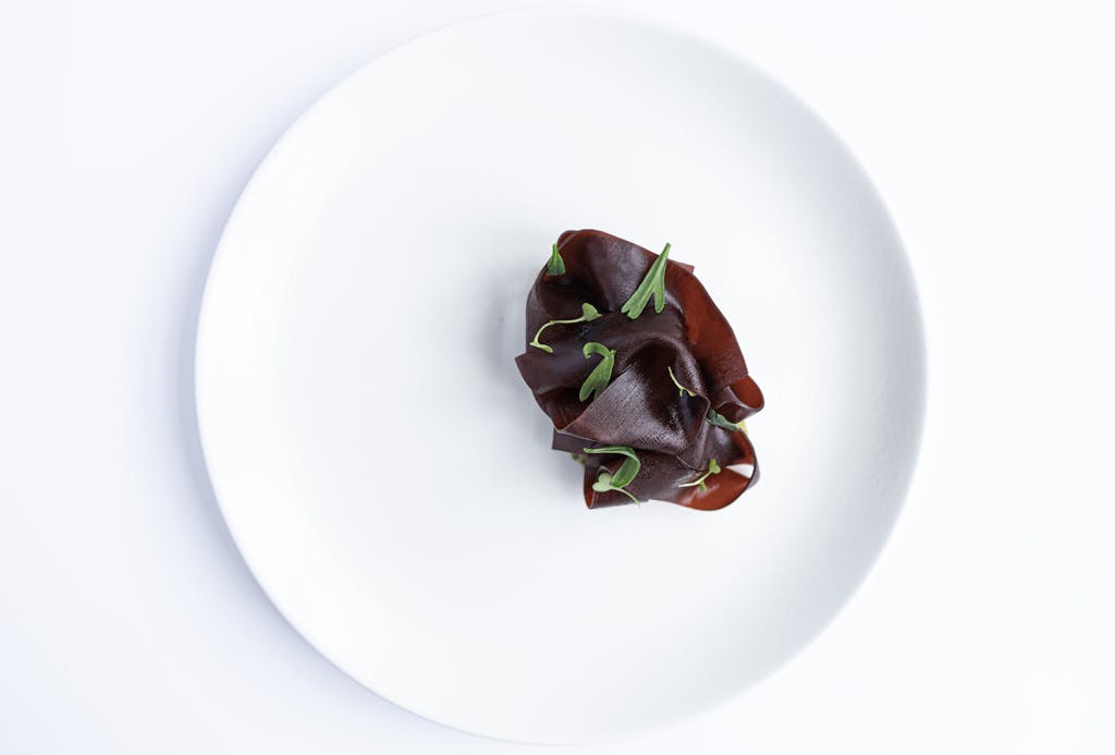 Artistic presentation of sliced beets on a white plate, capturing minimalist food styling.